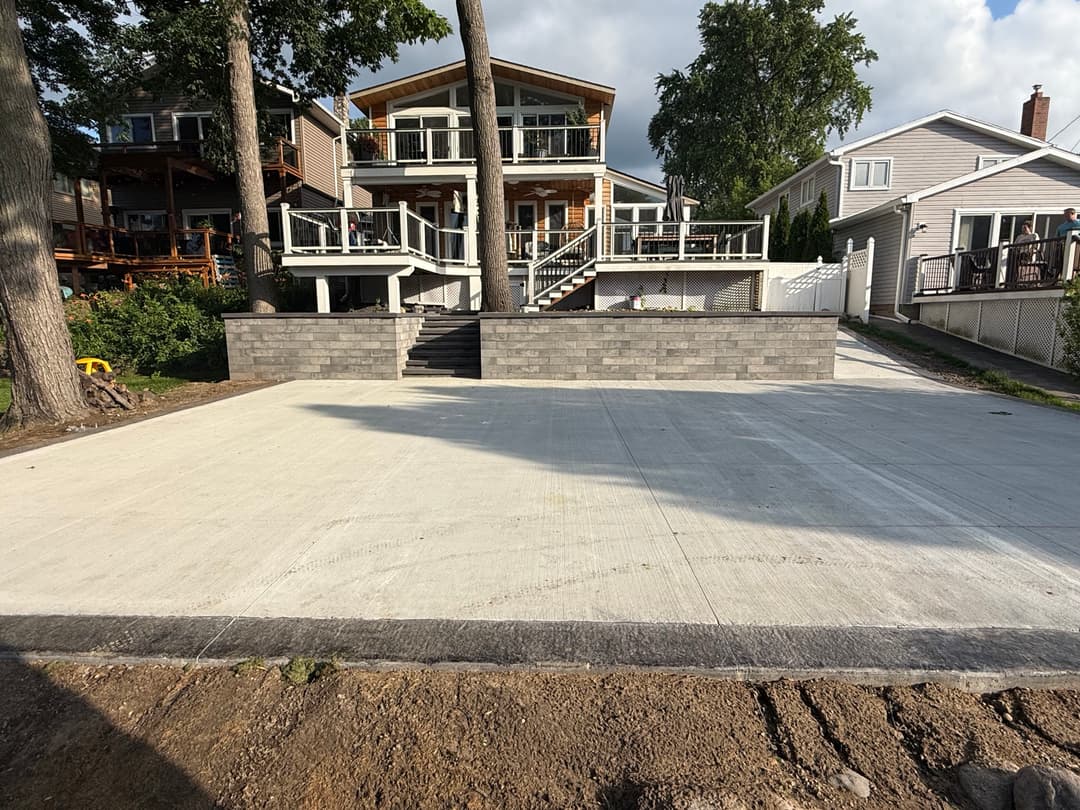 Newly constructed concrete surface ready for use, surrounded by landscaped homes and trees.
