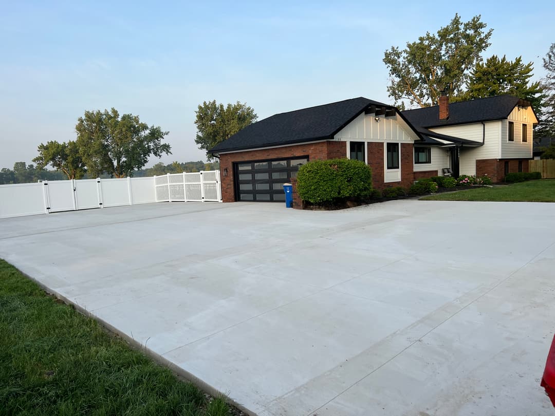 Modern suburban home with garage, landscaped yard, and spacious concrete driveway.