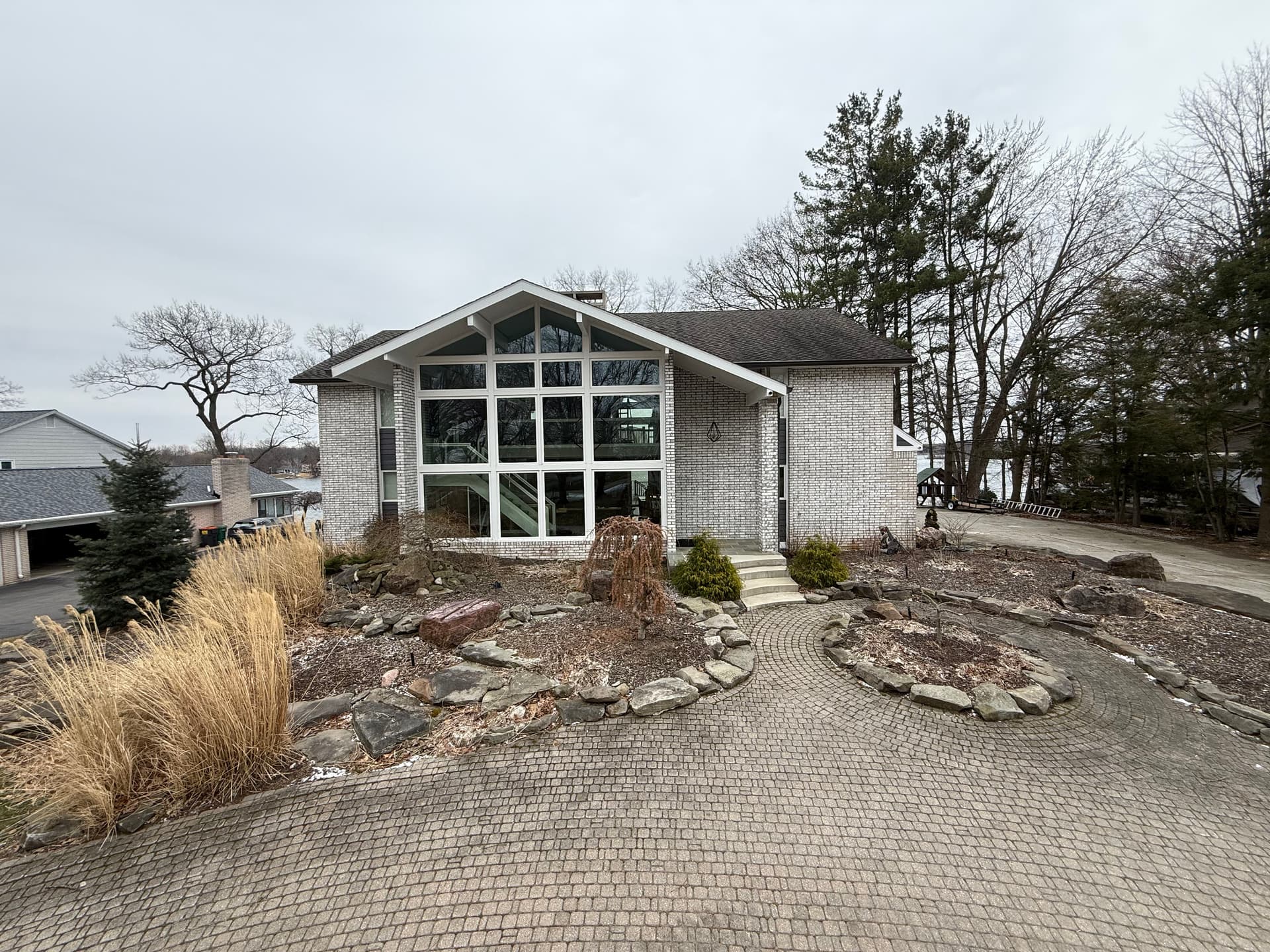 Modern Landscape Design with Retaining Walls, Concrete Driveway and Lighting image